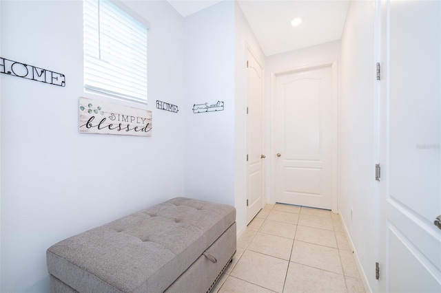 corridor with light tile patterned floors