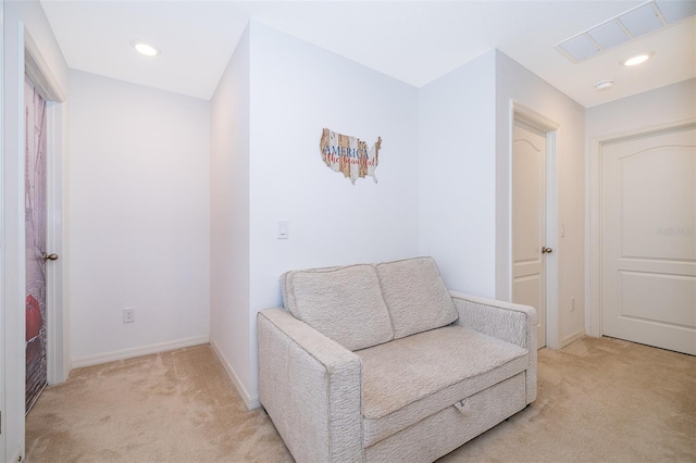 sitting room featuring light colored carpet