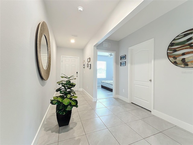 hall featuring light tile patterned flooring