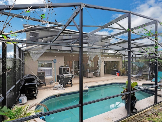 view of swimming pool with a lanai and a patio area