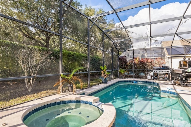 view of swimming pool featuring glass enclosure, an in ground hot tub, a patio, and grilling area