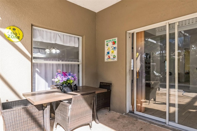 home office featuring concrete floors and a chandelier