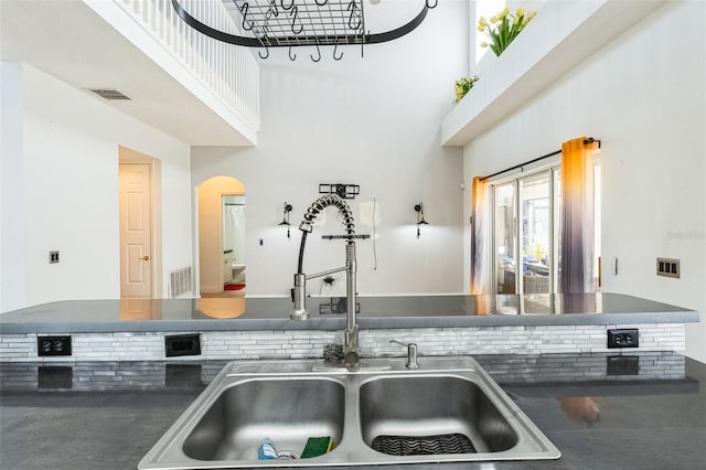 kitchen with a high ceiling and sink