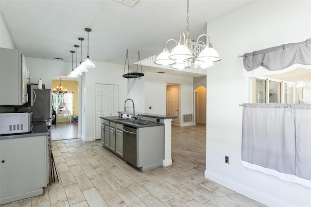 kitchen with stainless steel dishwasher, a kitchen island with sink, sink, pendant lighting, and gray cabinets