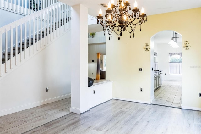 interior space featuring a chandelier and light hardwood / wood-style flooring