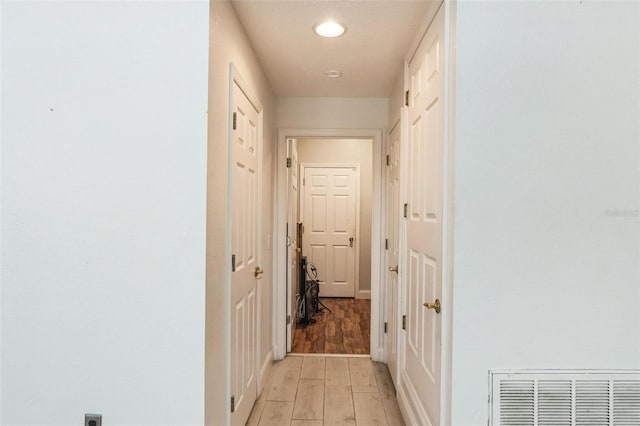 corridor featuring light hardwood / wood-style floors