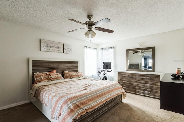 carpeted bedroom with a textured ceiling and ceiling fan