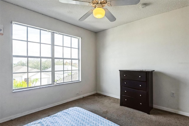 bedroom with a textured ceiling, carpet floors, and ceiling fan