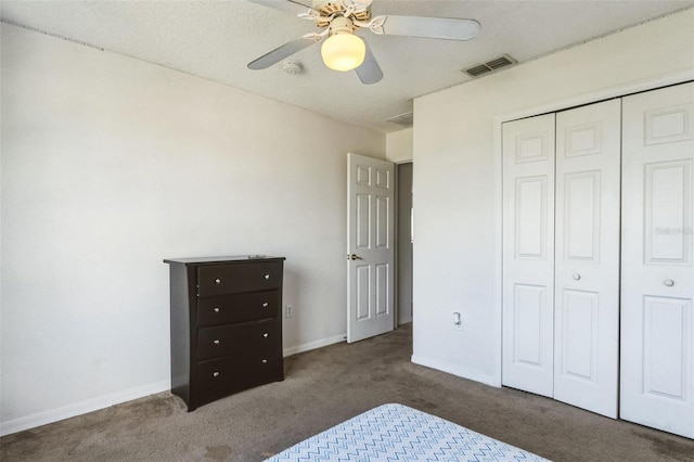 carpeted bedroom featuring ceiling fan and a closet