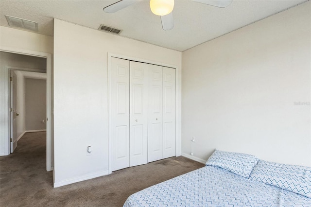 carpeted bedroom featuring a closet and ceiling fan