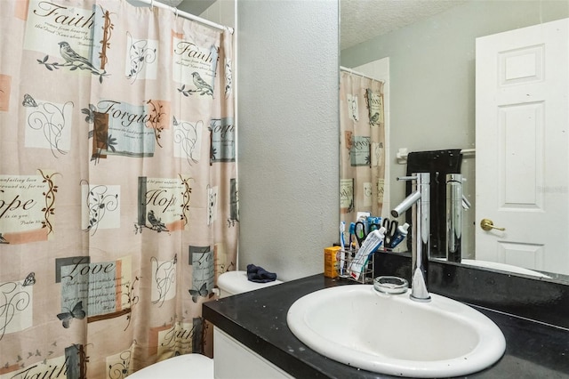 bathroom with vanity, a textured ceiling, toilet, and a shower with shower curtain