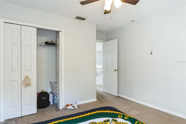 carpeted bedroom with a closet and ceiling fan