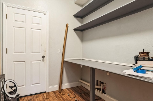 unfurnished office with dark wood-type flooring