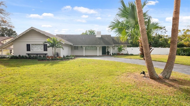 single story home with a front yard and a carport