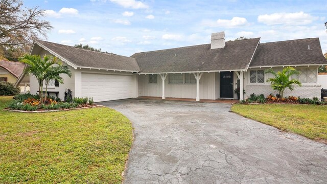 ranch-style house featuring a front lawn and a garage