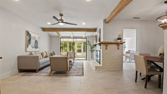 living room featuring ceiling fan, a fireplace, and beamed ceiling