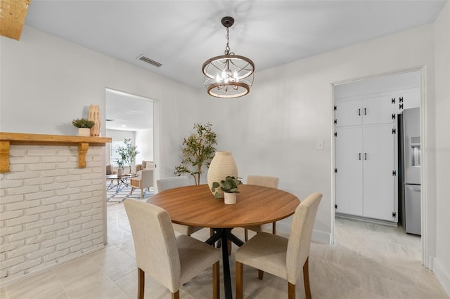 dining space with an inviting chandelier