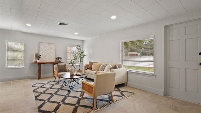 tiled living room with plenty of natural light