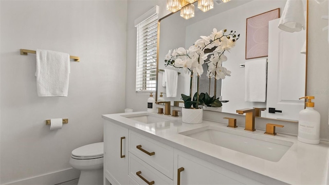 bathroom with vanity, toilet, and a wealth of natural light