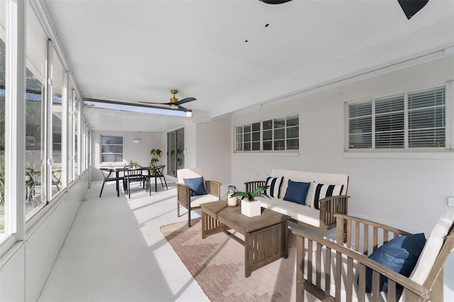 sunroom / solarium featuring ceiling fan