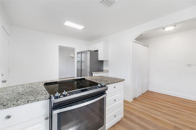 kitchen with white cabinets, visible vents, light wood-type flooring, and appliances with stainless steel finishes