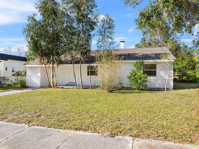ranch-style house with driveway, a garage, and a front lawn