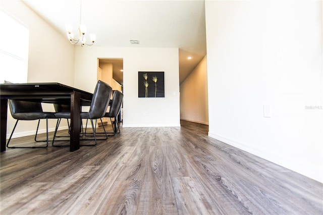 dining room with an inviting chandelier and hardwood / wood-style flooring