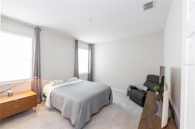 bedroom featuring light carpet