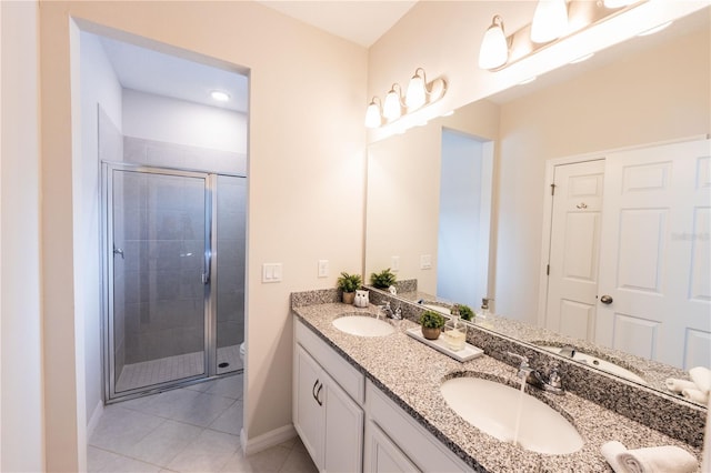 bathroom featuring tile patterned flooring, vanity, and walk in shower