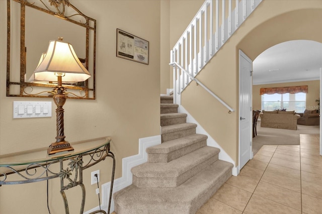 stairway featuring tile patterned flooring