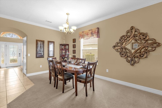 tiled dining room featuring an inviting chandelier, a wealth of natural light, and ornamental molding