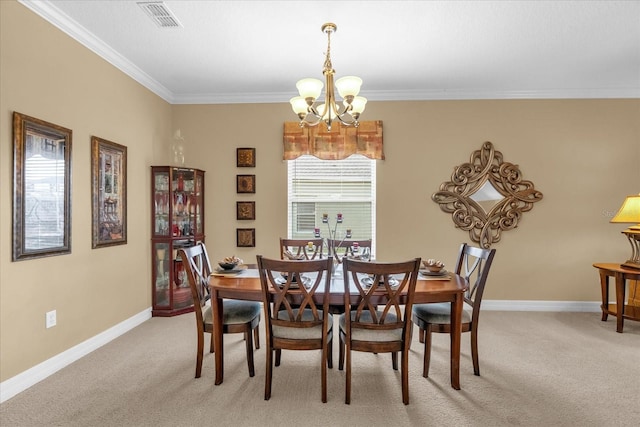 carpeted dining space featuring a chandelier and ornamental molding