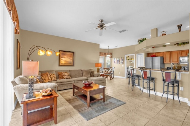 living room featuring ceiling fan and light tile patterned floors