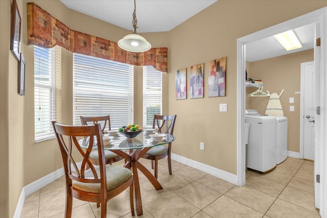 tiled dining space with washing machine and clothes dryer