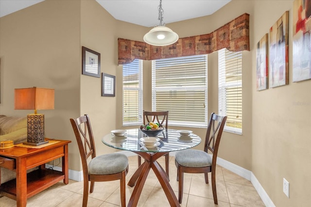 dining area featuring plenty of natural light and light tile patterned floors