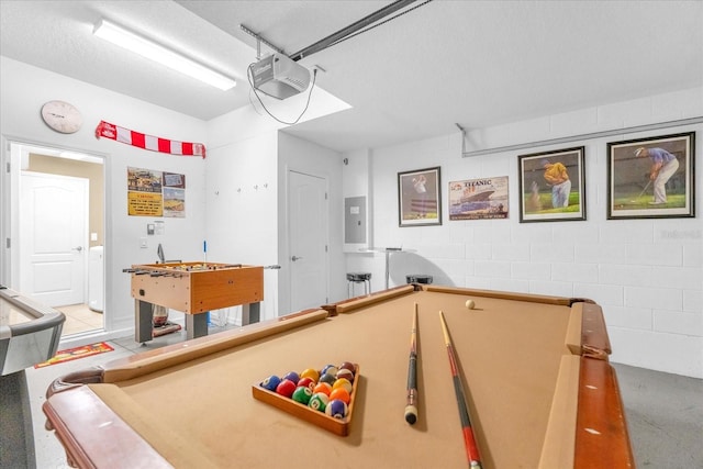 game room with electric panel, washer / clothes dryer, a textured ceiling, and pool table