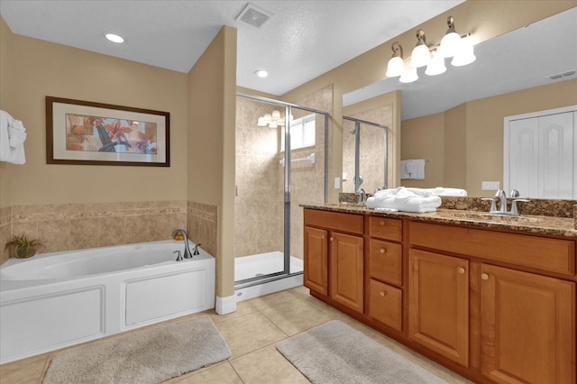 bathroom featuring tile patterned floors, vanity, and shower with separate bathtub