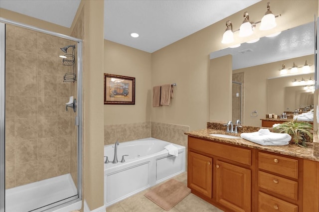 bathroom with tile patterned floors, vanity, and separate shower and tub