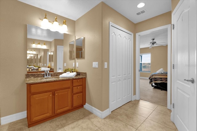 bathroom featuring tile patterned flooring, ceiling fan, and vanity