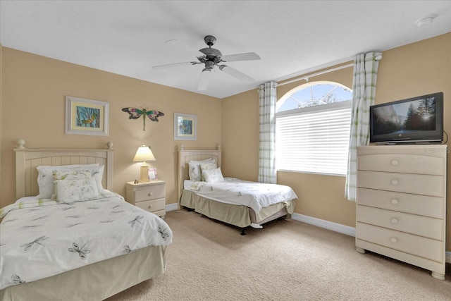 bedroom with ceiling fan and light carpet