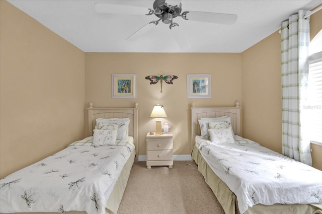 bedroom with ceiling fan and light carpet