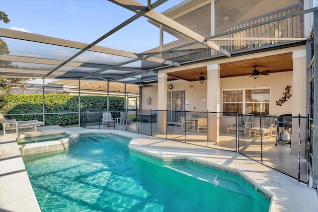 view of swimming pool featuring a lanai, ceiling fan, a patio, and an in ground hot tub