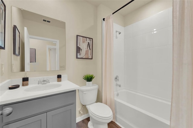 full bathroom with shower / tub combo, vanity, hardwood / wood-style flooring, and toilet