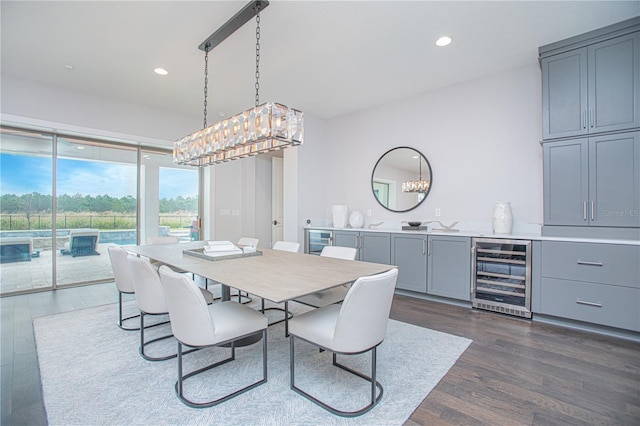 dining space featuring dark wood-type flooring, wine cooler, and recessed lighting