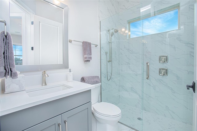 full bath featuring toilet, a stall shower, and vanity