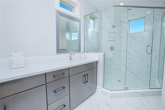 bathroom featuring marble finish floor, a stall shower, and vanity