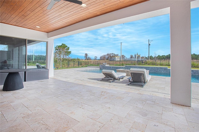 view of patio / terrace featuring a fenced in pool, a fenced backyard, and a ceiling fan