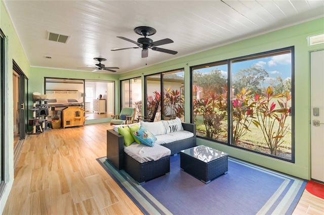 sunroom with ceiling fan