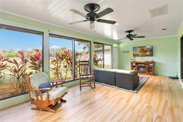 sunroom featuring ceiling fan