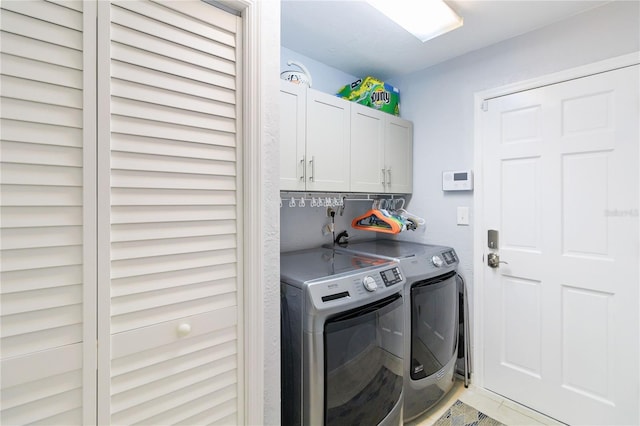 laundry area featuring cabinets and washing machine and dryer